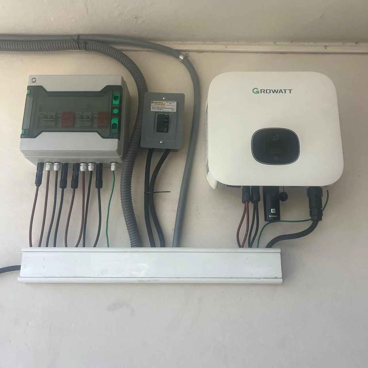 Inversor Growatt instalado en pared exterior, junto a centro de carga